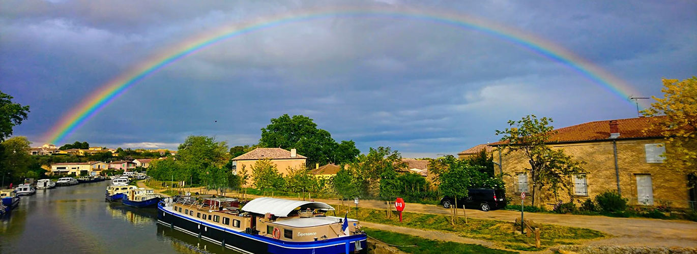 Canal du Midi barge cruise Esperance moored under a rainbow